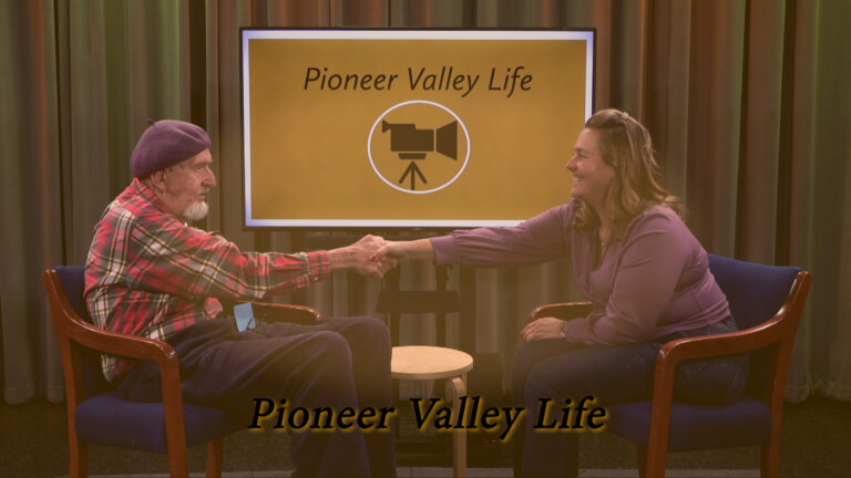 James Sullivan and Angela Park shaking hands with smiles