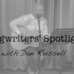 richard dubuc playing the guitar and singing with the words songwriter's spotlight over him